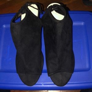 Gently worn black pumps that tie in the back